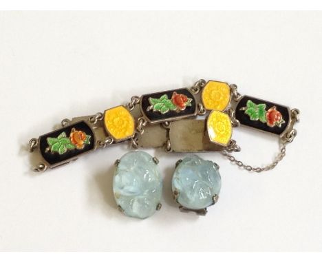 A pair of Art Deco blue glass Lalique style clip earrings together with an Art Deco silver and enamel bracelet, decorated wit