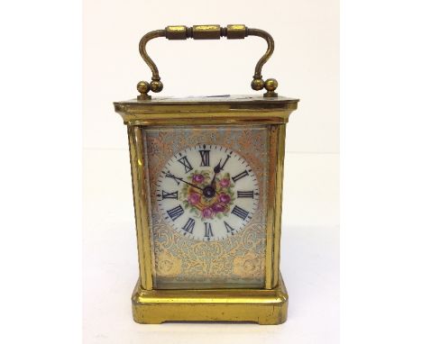 An enamel decorated glass and brass cased carriage clock.