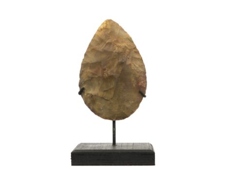Presumably prehistoric two-sided axe head with typical characteristics of the Mousterian, named after the archaeological site