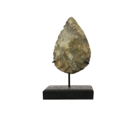 Presumably prehistoric two-sided axe head with typical characteristics of the Mousterian, named after the archaeological site