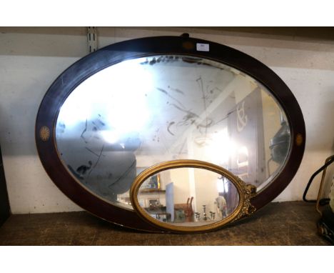 An inlaid mahogany oval mirror and a small gilt framed mirror 