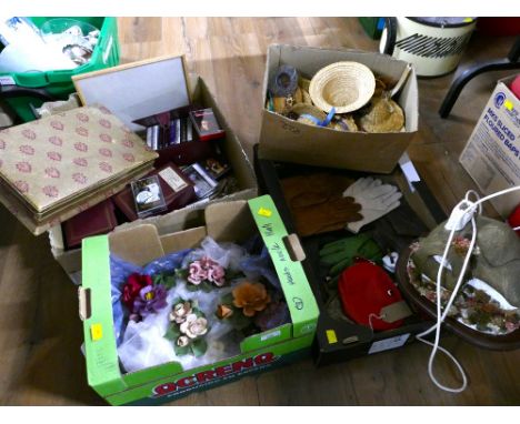 Four boxes of porcelain Capodimonte flowers, cottage lamp base, wicker dolls hats, music cassettes etc 