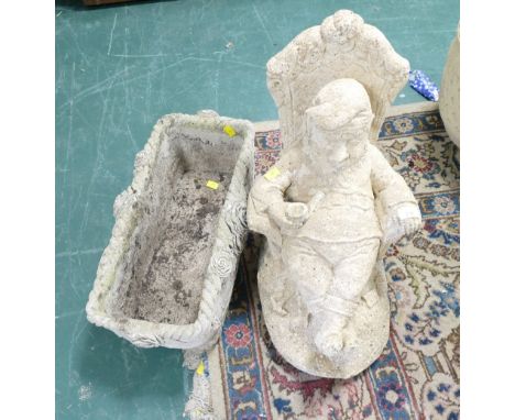Garden ornament, recumbent gnome smoking a pipe with his feet crossed, and trough