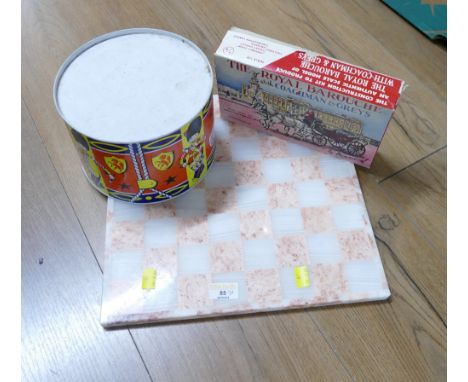 Pink marble chessboard, vintage tin drum and Paramount Royal Coach model kit 