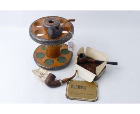 Three vintage pipes in wooden pipe stand and tin of Gold Block tobacco