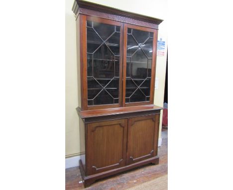 Late 19th century mahogany library bookcase, the lower  section enclosed by a pair of panel doors, the upper by a pair of ast