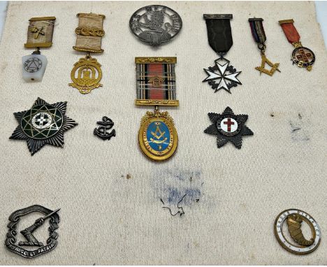 A card bearing a series of Masonic and other regalia including highland clan brooches, a Royal Order of Scotland badge, Knigh