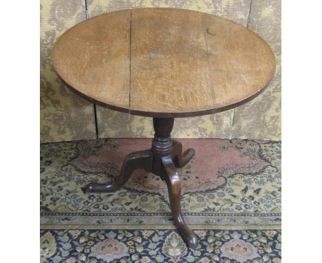 A Georgian oak snaptop table, raised on a turned pillar and tripod, 75c diameter 