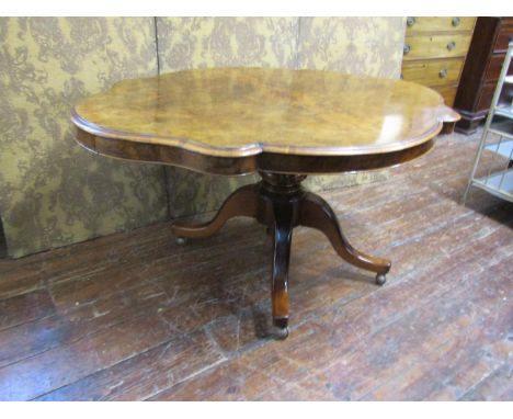 A Victorian walnut and figured walnut loo table with quarter veneered top, shaped outline and raised on a turned pillar, 145 