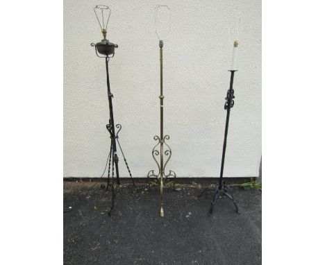 A 19th century brass and iron telescopic lamp standard adapted for electricity, another in brass with lions paw feet and a la