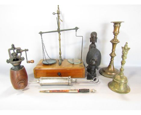 A vintage pepper or nutmeg grinder, together with various other items, including two wood African carving a chemist’s scale, 