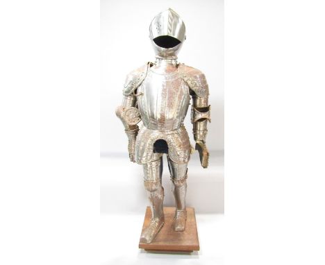 A miniature full set of 16th century style armour displayed on a mannequin set on a wooden base. 77cm tall. 
