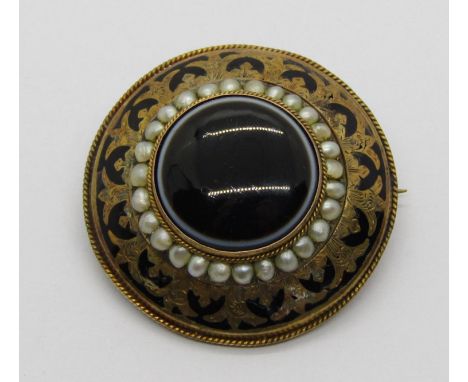 Victorian yellow metal mourning brooch with black enamel border and central agate within seed pearl surround, the reverse con
