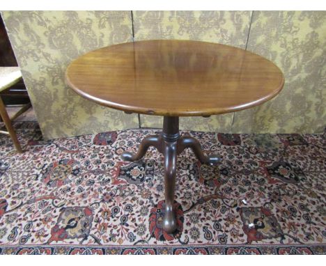 A Georgian mahogany snaptop table raised on a turned pillar and bird cage, with tripod base, the top 90cm 