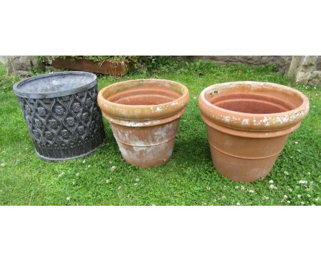 A pair of weathered terracotta outsized flower pots with moulded rims, approx 50 cm diameter x 42 cm high together with a com