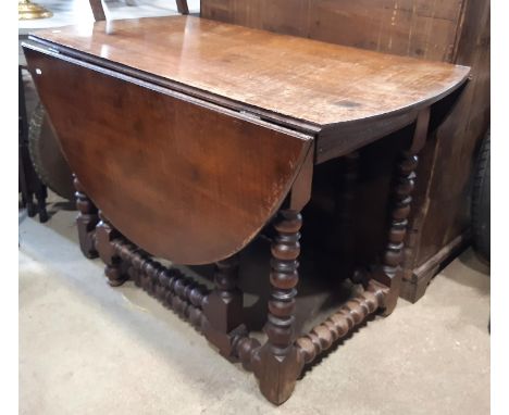 An 18th century oak gateleg table, on bobbin supports and rails incorporating a frieze drawer, 120cm long 