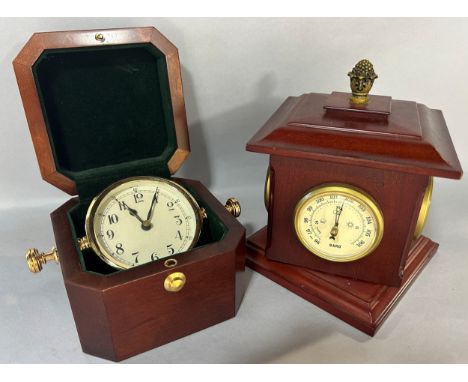 A late 19th century brass anniversary or 400 day clock with column supports, set beneath a glass dome on a brass base, togeth