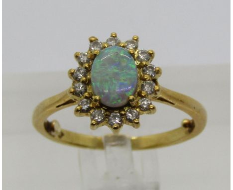 18ct opal and diamond cluster ring, London 1983, size J/K, 3.8g (sizing beads) 