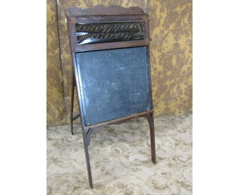 A late 19th century American child's folding easel enclosing a blackboard, the upper panel showing an American pastoral view,