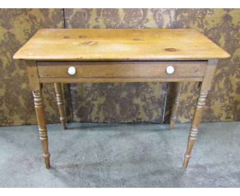 A Victorian stripped pine side table fitted with a slender frieze drawer raised on ring turned and tapered supports, 100cm wi