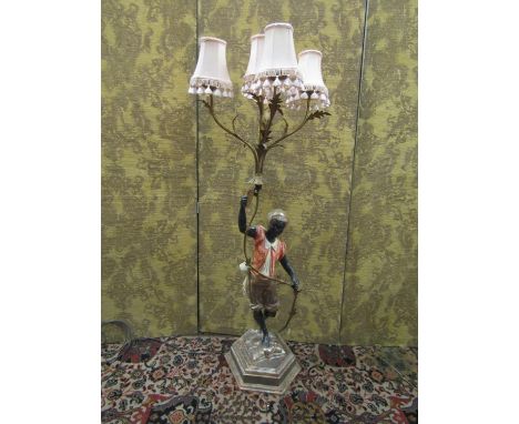 An Italian polychrome candelabra, the hexagonal base supporting a male character holding aloft a five branch sconce, fitted f