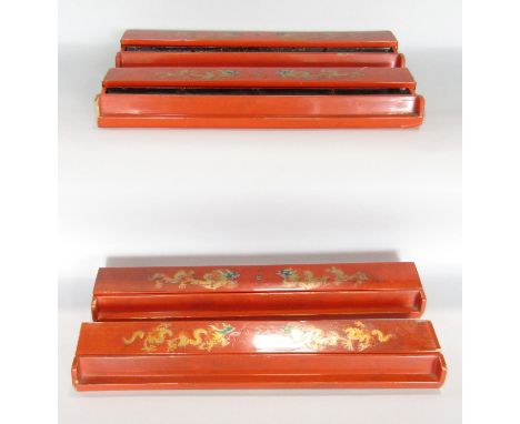 Four orange lacquered, with gold painted dragon mahjong tile holders, in need of some repair. 