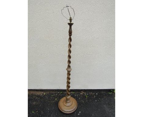 A good quality pale walnut and beech lamp standard on tapering spiral twist column 