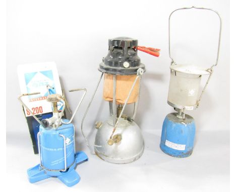A Vapalux paraffin Hurricane Lamp, a Camping Gaz lamp and S 200 burner, together with six gas canisters. 