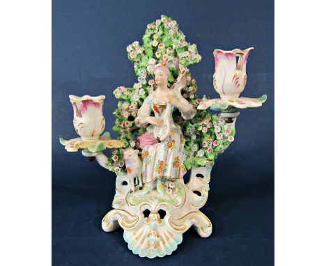 A 19th century continental porcelain candelabrum with bocage back to the centre a female playing a lute accompanied by a shee