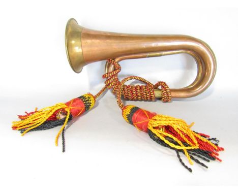 A copper and brass Military bugle with Royal Artillery tassel. (Lacks mouth piece). 
