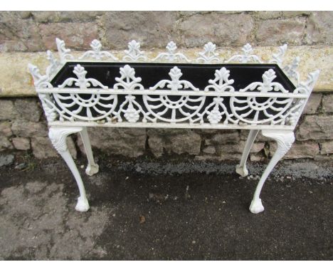 A Victorian style painted cast aluminium flower trough/planter with decorative pierced detail, raised on claw and ball suppor