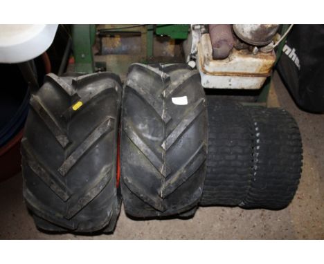 A pair of 18 x 9.50/8 lawn tractor wheels with a pair of front lawn tractor wheels