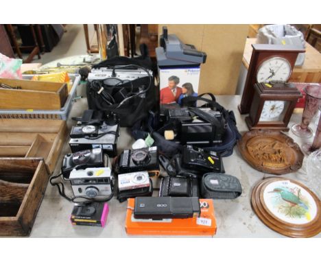 A quantity of various cameras to include Polaroid, Samsung, Canon etc.