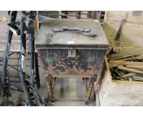 A barleytwist stool and metal trunk