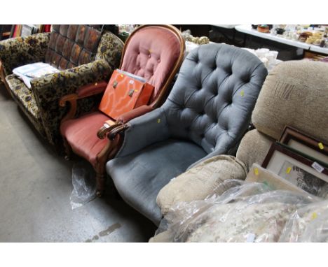 A blue upholstered button back slipper chair
