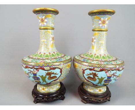 A pair of Chinese cloisonné enamel vases decorated to the body with panels of auspicious and scholarly objects set amongst st