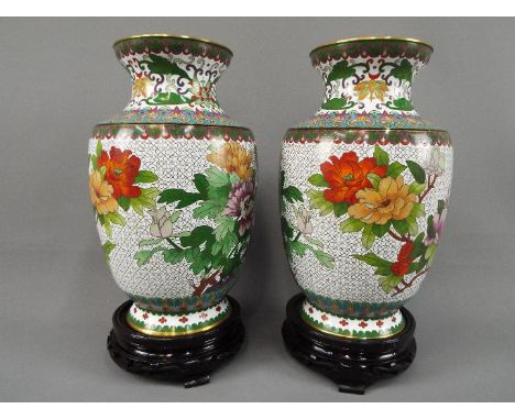 A pair of Chinese cloisonné vases decorated with flowers, birds and insects on a white ground, stylised lotus scroll to the n