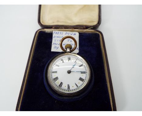 A lady’s silver cased pocket watch, case having engraved decoration, white enamel dial with Roman numerals and gold half hour
