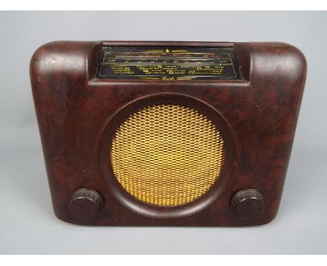 An Art Deco style 1950's Bush Radio, model D.A.C. 90A, dark brown Bakelite case with gold metal grille, volume and tuning kno