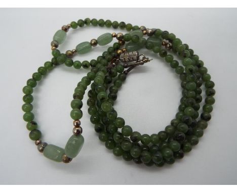 A twin strand jade or hardstone necklace, approximately 47 cm (l), with lines of spherical beads (approximately 4 mm diameter