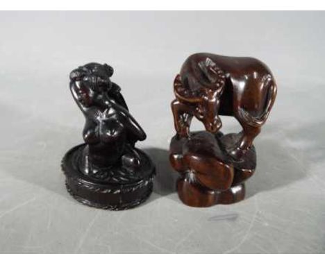 A vintage Japanese dark wood Netsuke depicting a lady bathing, signed and a vintage dark wood Japanese Netsuke depicting a ho