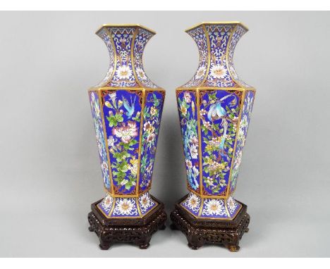 A large pair of Chinese hexagonal section cloisonné vases, each panel of the body decorated with flowers, birds and insects a