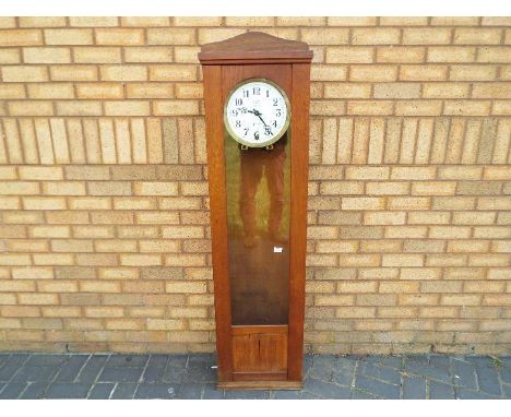 An early 20th century regulator wall clock signed to the 10 inch white enamel dial for JG Baer, Sumiswald, Switzerland, P.T.T