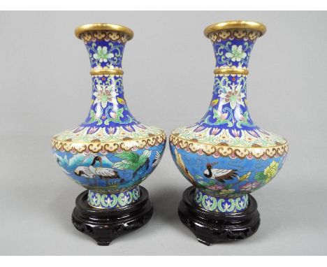 A pair of Chinese cloisonné vases decorated to the body with Red Crowned Cranes in a landscape setting, stylised lotus scroll