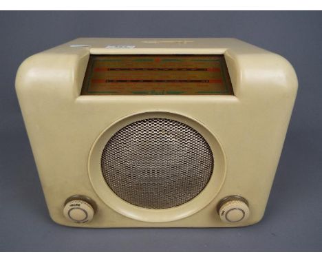 An Art Deco style 1950's Bush Radio, model D.A.C. 90A, ivory Bakelite case with silver metal grille, volume and tuning knobs,