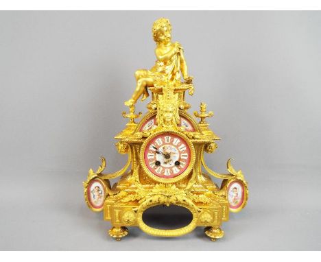 An impressive, ormolu cased French mantel clock of classical form and having the figure of a seated young boy on the top, ins