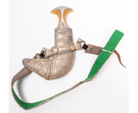 An Arab jambiya with scabbard, embellished with silvered braid and white metal, on its braided belt. VGC £50-70 