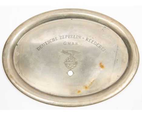 An oval nickel silver mess tray, engraved "DEUTSCHE ZEPPELIN REEDEREI G.M.B.H" above an eagle on a globe with airship and swa