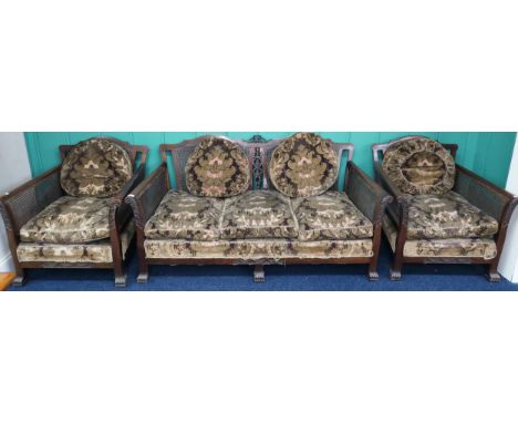 A late Victorian mahogany framed three piece bergere suite with Damask upholstered cushions two seater sofa, 79cm high x 165c