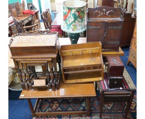 A lot comprising an oak coffee table, nest of three tables, piano stool, hanging smokers cabinet, oak wall shelf, inlaid writ